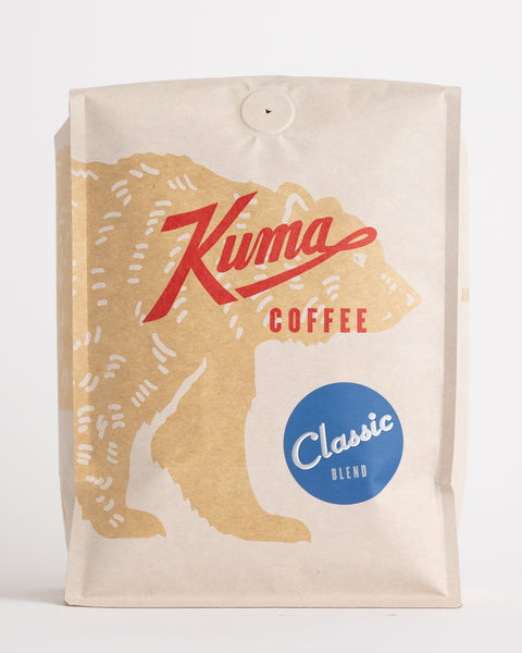 Kuma Coffee Craft coffee bulk bag compostable coffee of classic Kuma blend, showing big coffee bear wrapping around the bag and Classic blend blue sticker beneath