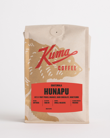 craft bag of specialty coffee, kuma coffee logo with coffee bear wrapped around the front of the bag, Guatemala Hunapu on the label, with notes of fruit punch, oranges, dark chocolate and honeycomb, region antigua, high elevation 1800 m, small holder farmers, washed cleaning process