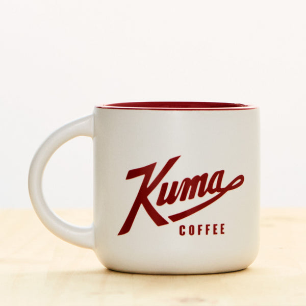 white 14 oz stoneware coffee mug with red interior and Kuma Coffee logo in red on side